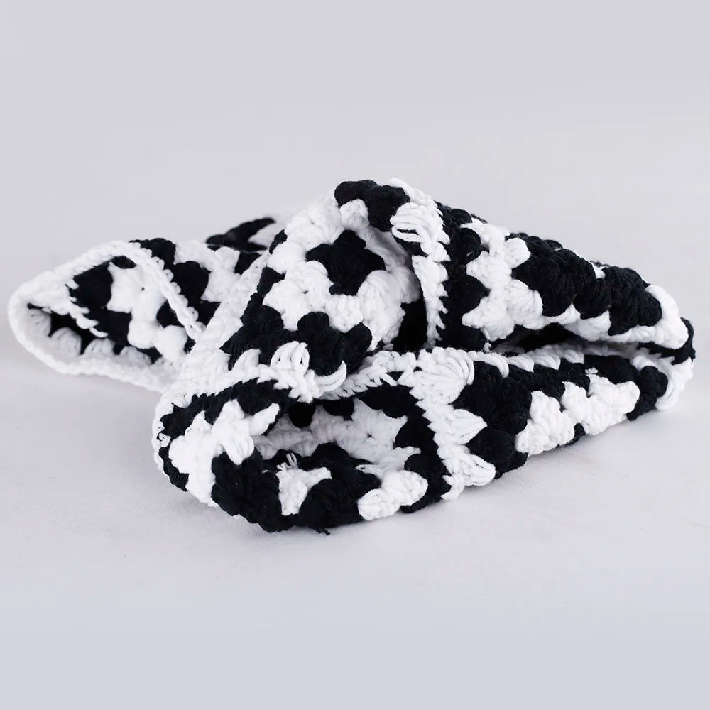 Pair of black and white patterned fuzzy slippers from BALACLAVA KNIT WOMENS PEORIA collection