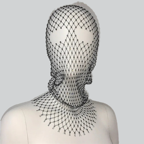 Intricate black mesh headpiece on a white mannequin showcasing a designer balaclava