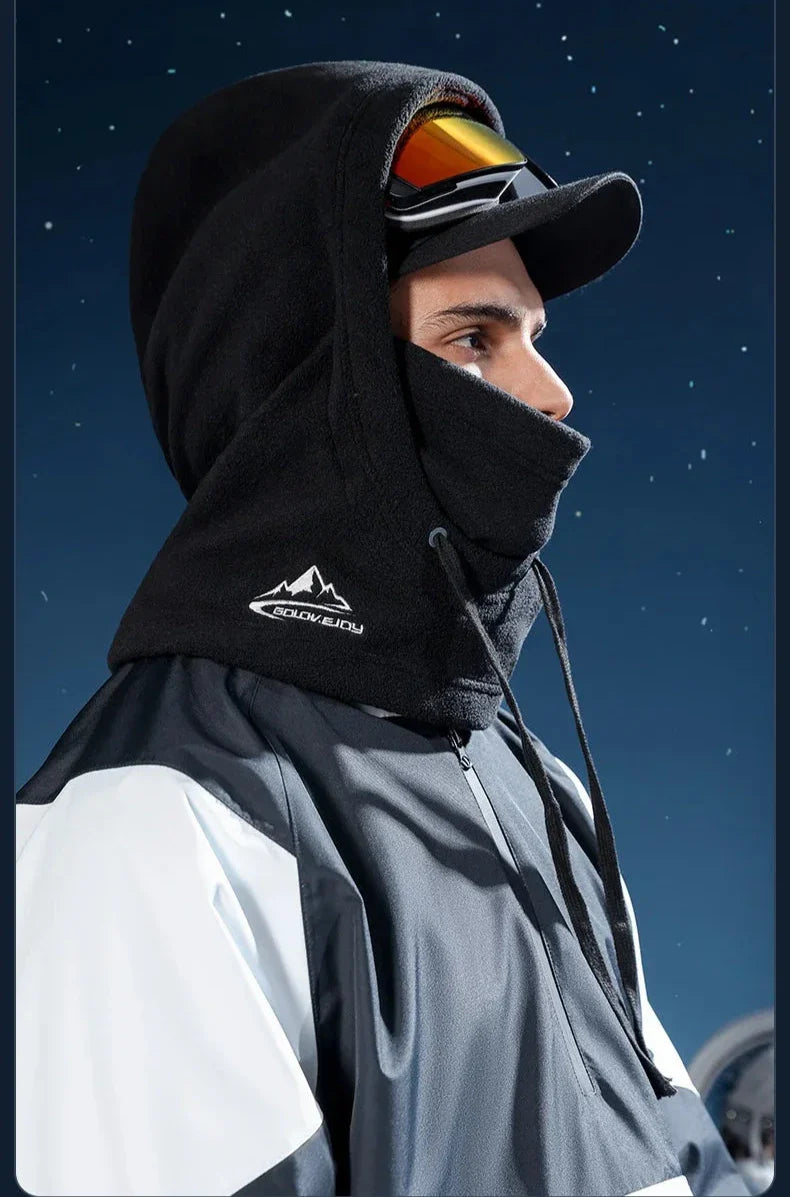 Skier in a black balaclava hood and goggles for winter sports protection