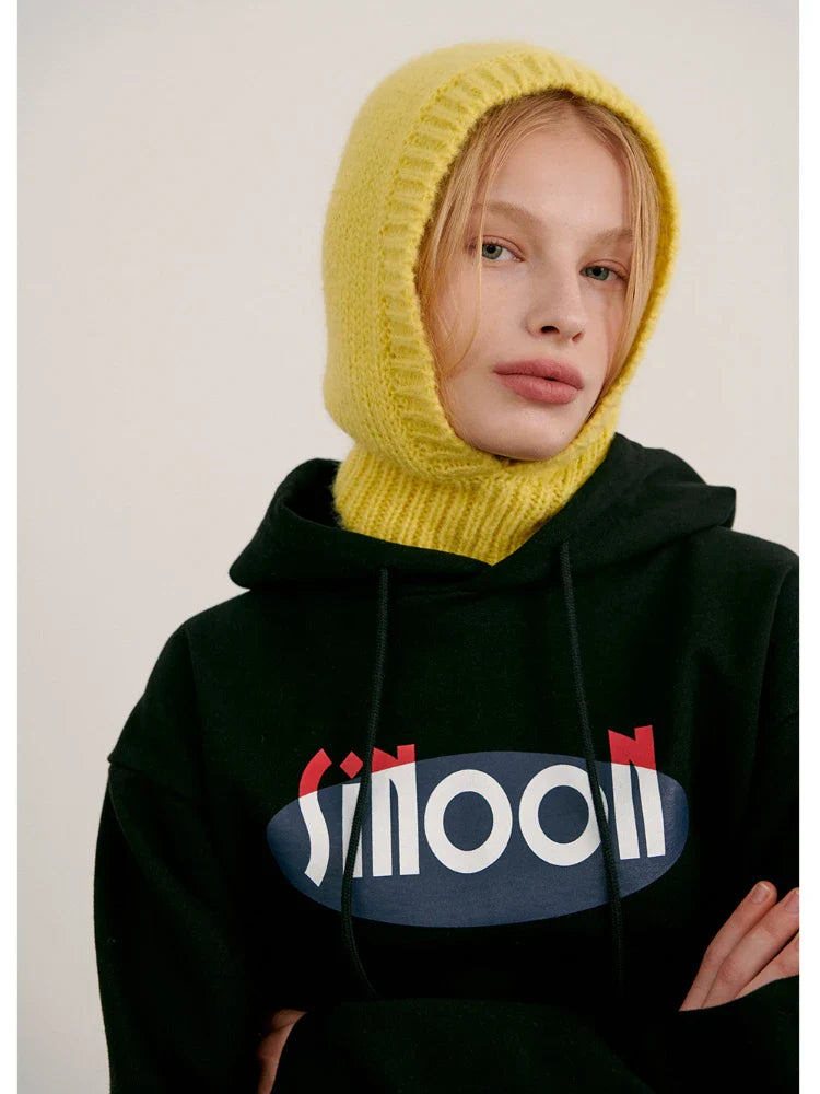 Person in a black hoodie with Smooth text and bright yellow knitted balaclava hood