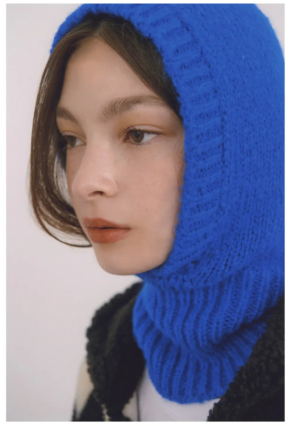 Woman in a bright blue knitted hood from the Ladies Knitted Balaclava collection