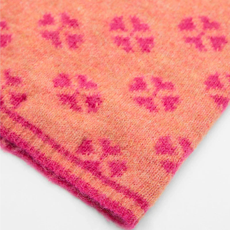 Peach-colored knit fabric with pink floral patterns on Pink Knitted Balaclava Anderson