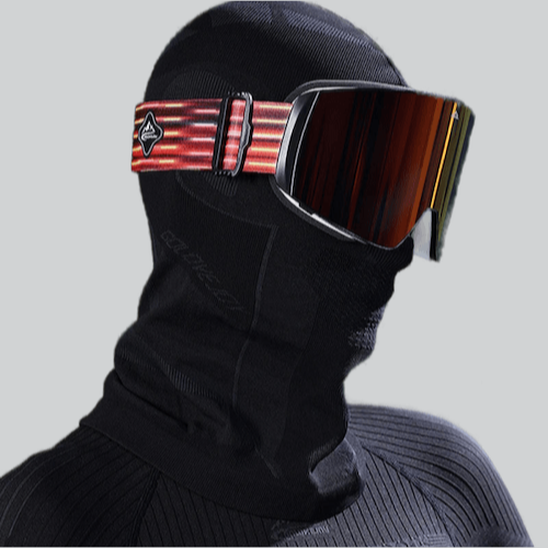 Ski goggles with striped strap on person wearing a thermal motorcycle balaclava