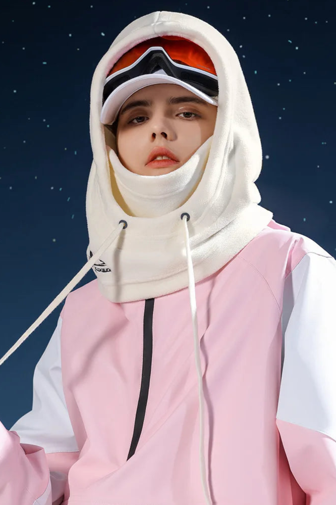 Person in winter sports attire featuring a White Balaclava Hood and pink jacket