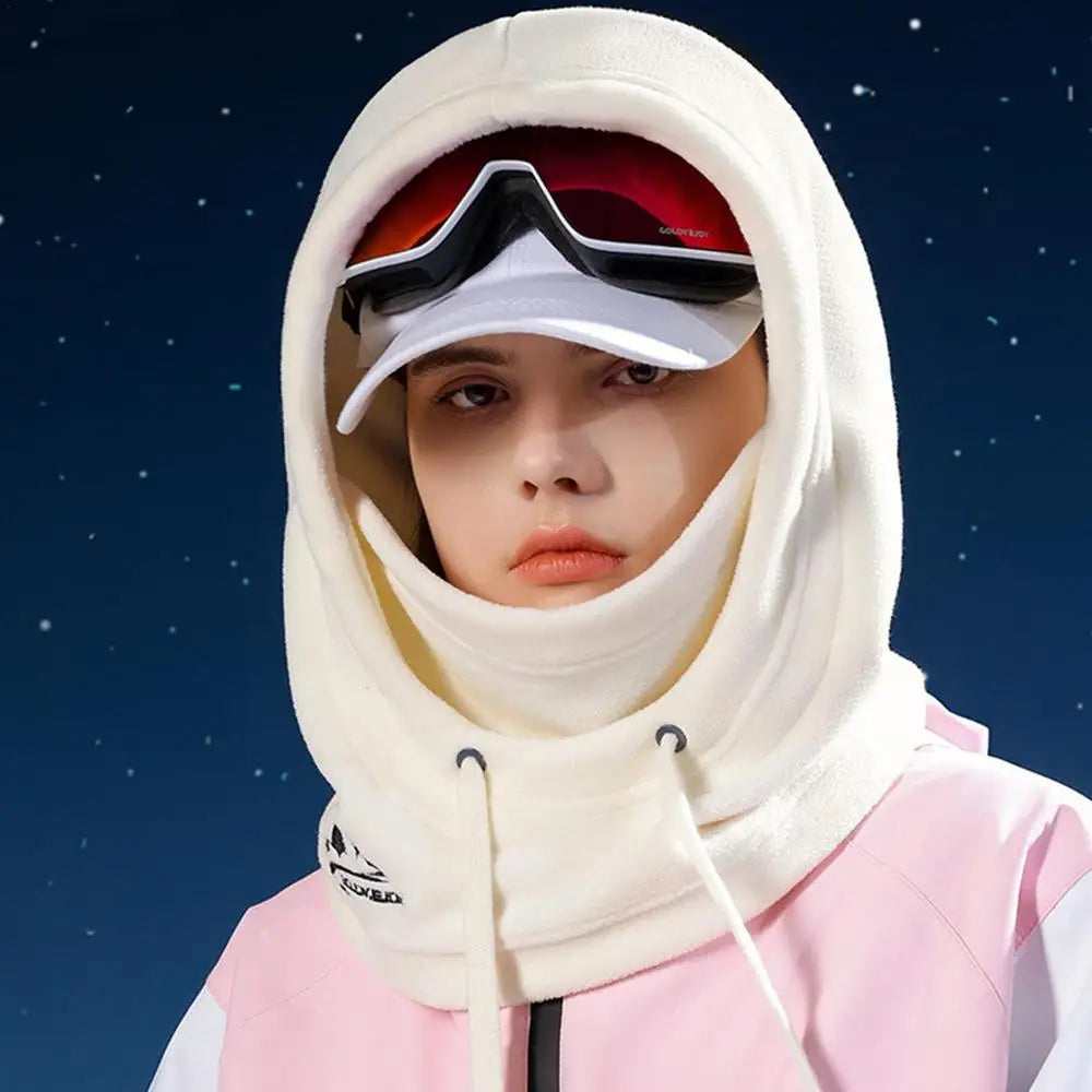 Person wearing a white balaclava hood and red-tinted goggles in starry background