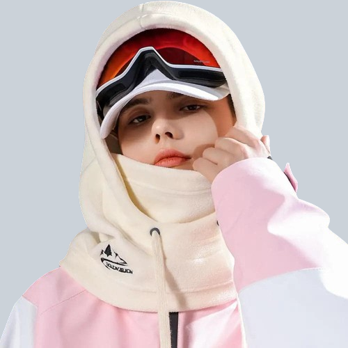 Skier in white balaclava hood and pink jacket, showcasing style and warmth