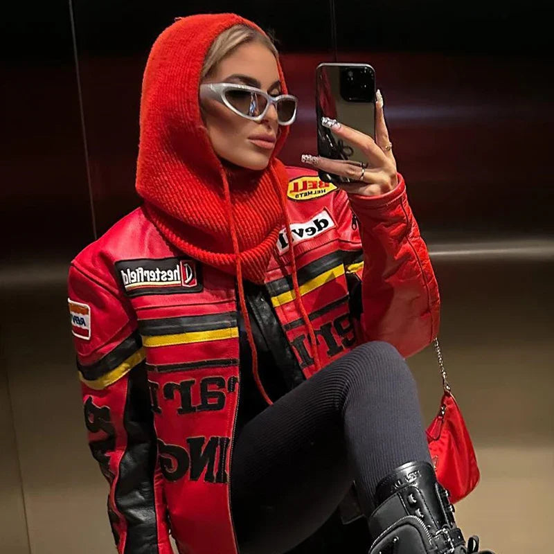 Person in a red racing jacket with logo and matching knit balaclava taking a mirror selfie