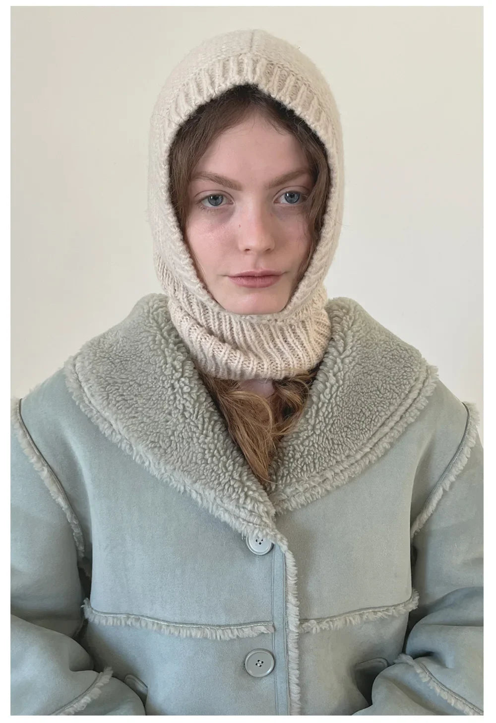 Person in light blue coat wearing cream wool balaclava knit from Davenport